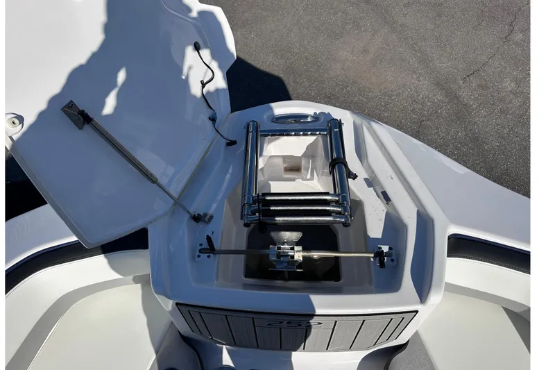 Slide: The Image of Open anchor compartment of 2021 Yamaha Boats 252S, showcasing ladder and storage. - 45