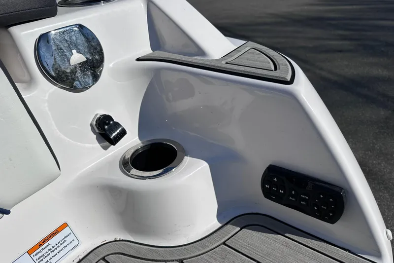 Slide: The Image of 2021 Yamaha Boats 252S interior detail with cup holder and control panel. - 48