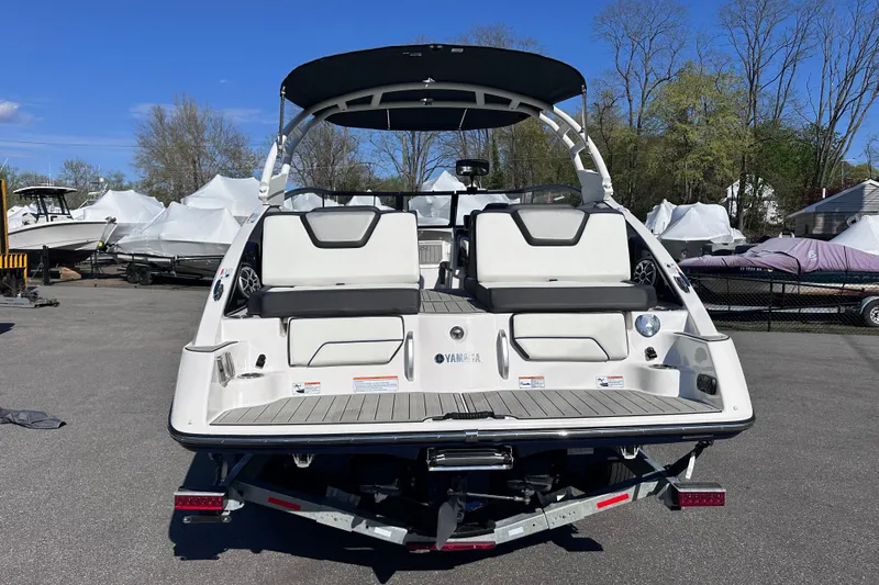 Slide: The Image of 2021 Yamaha Boats 252S with sleek design, spacious seating, and modern features, parked outdoors. - 6
