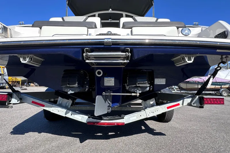 Slide: The Image of Rear view of 2021 Yamaha Boats 252S on trailer, showcasing dual engines and sleek design. - 7