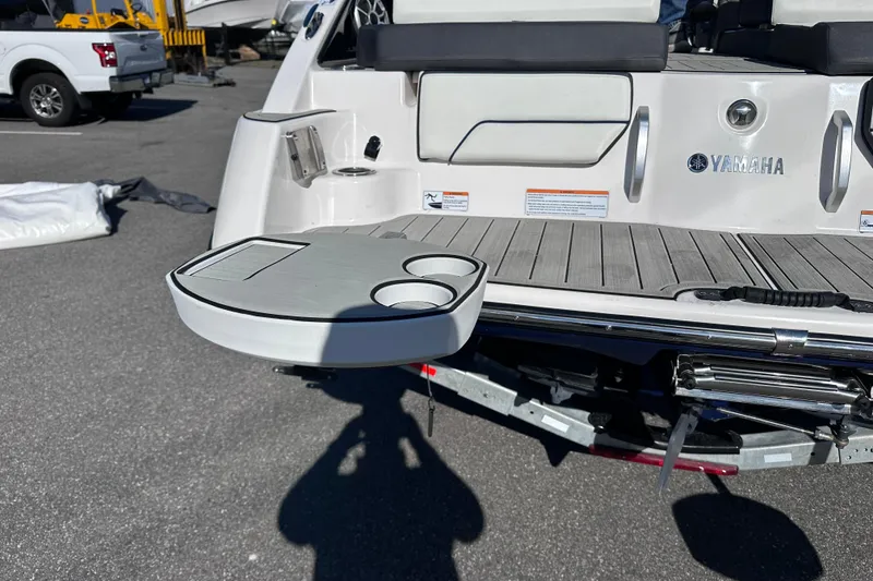 Slide: The Image of 2021 Yamaha Boats 252S swim platform with cup holders and seating area. - 8