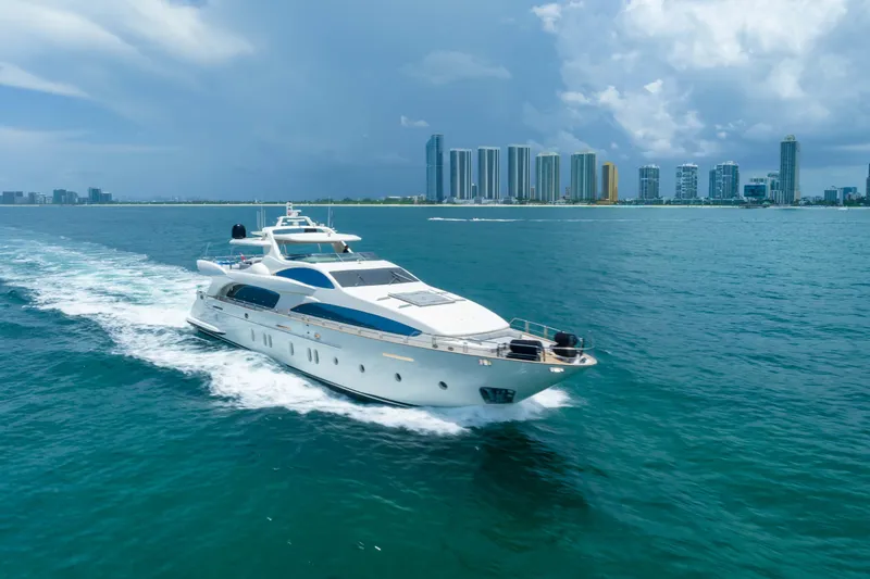 The Image of Luxurious 2012 Azimut yacht cruising near a city skyline under a cloudy sky. - 0