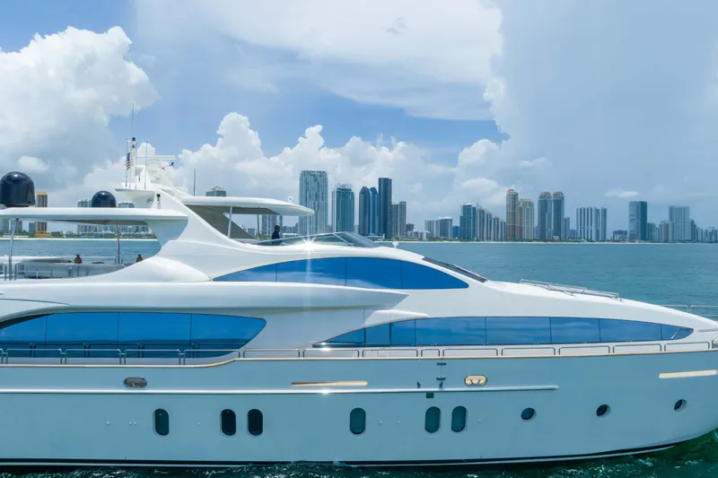 Slide: The Image of Luxurious 2012 Azimut yacht cruising near a city skyline under a bright blue sky. - 13
