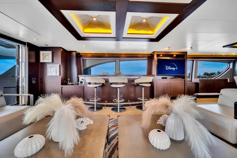 Slide: The Image of Luxurious 2012 Azimut yacht interior with modern bar, elegant decor, and Disney+ on TV. - 29