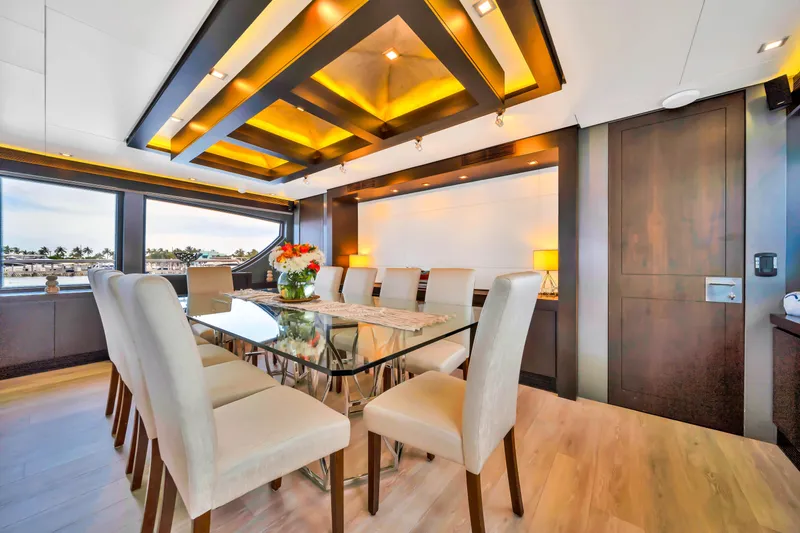 Slide: The Image of Luxurious dining area on a 2012 Azimut yacht with elegant decor and panoramic windows. - 32