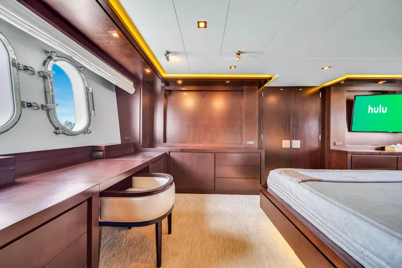 Slide: The Image of Luxurious Azimut yacht interior, 2012 model, featuring elegant wood paneling and a porthole view. - 42