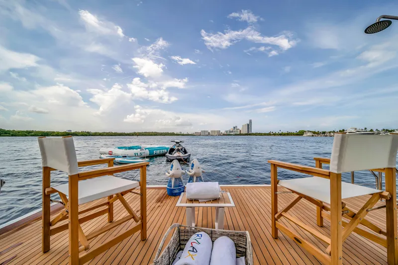 Slide: The Image of Luxury yacht deck with chairs, overlooking serene water and city skyline, Azimut 2012. - 49