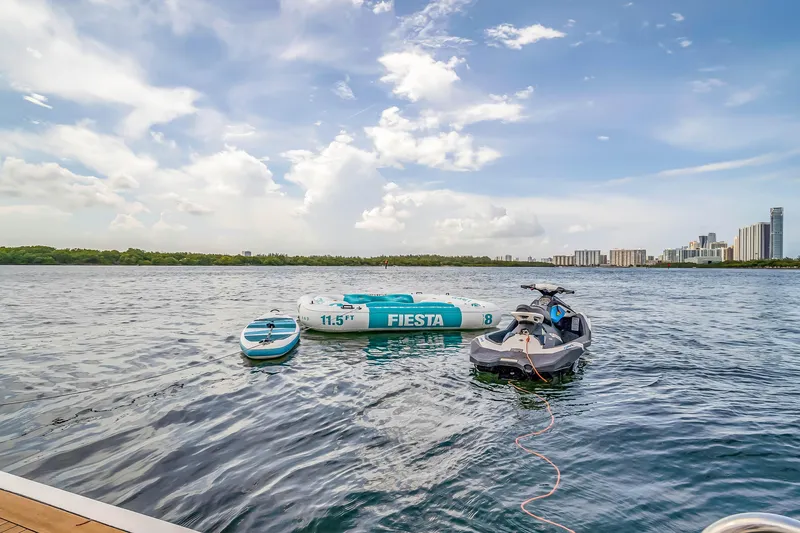 Slide: The Image of Jet ski and inflatable raft on water near city skyline, Azimut 2012. - 51