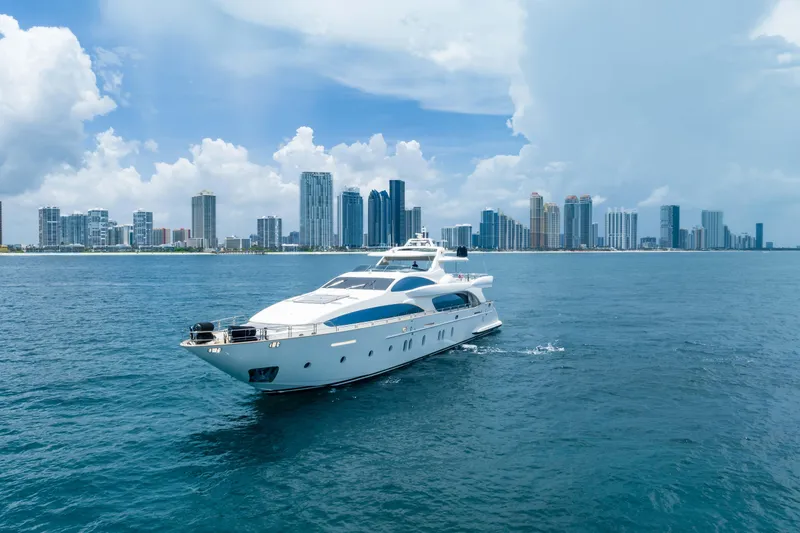 Slide: The Image of Luxurious 2012 Azimut yacht cruising near a modern city skyline under a partly cloudy sky. - 6