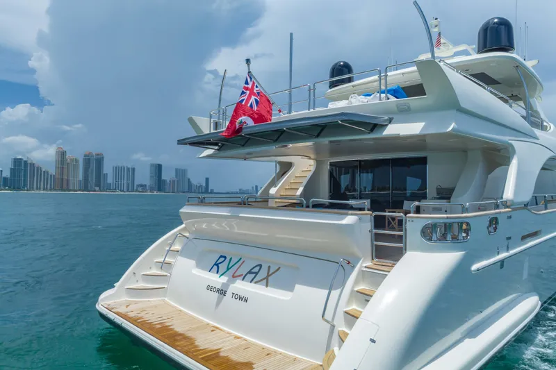 Slide: The Image of Luxurious 2012 Azimut yacht cruising near city skyline, featuring elegant design and spacious deck. - 9