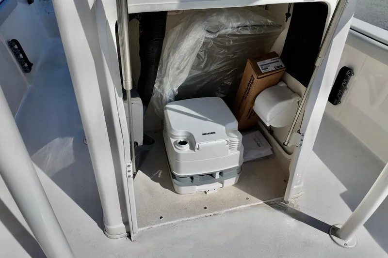Slide: The Image of Storage compartment in a 2026 Carolina Skiff 21 LS boat with portable toilet. - 11