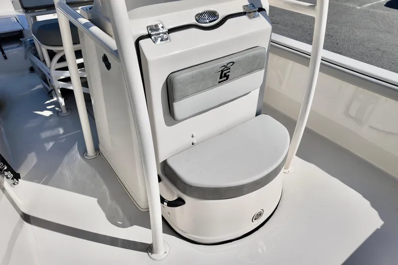 Slide: The Image of 2026 Carolina Skiff 21 LS boat interior with cushioned seating and storage compartment. - 12