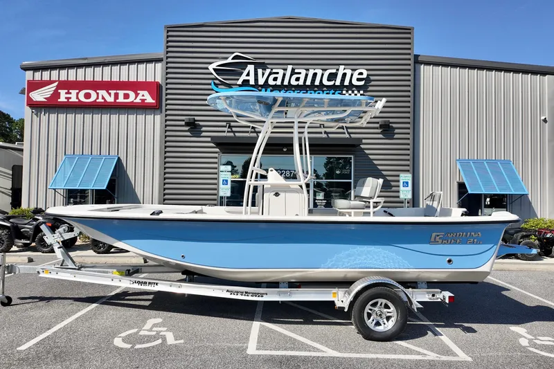 The Image of 2026 Carolina Skiff 21 LS boat on trailer outside Avalanche Motorsports dealership. - 2