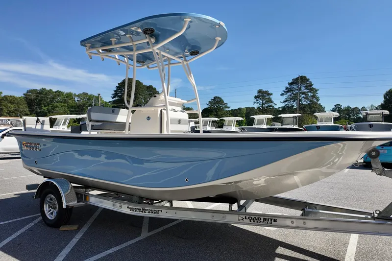 Slide: The Image of 2026 Carolina Skiff 21 LS boat on trailer, parked outdoors under clear blue sky. - 4