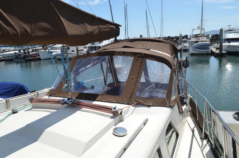 Slide: The Image of 1980 Cooper 416 Pilothouse yacht docked in marina under clear blue sky. - 15