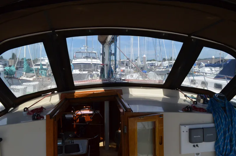 Slide: The Image of Interior view of 1980 Cooper 416 Pilothouse sailboat docked at a marina. - 16
