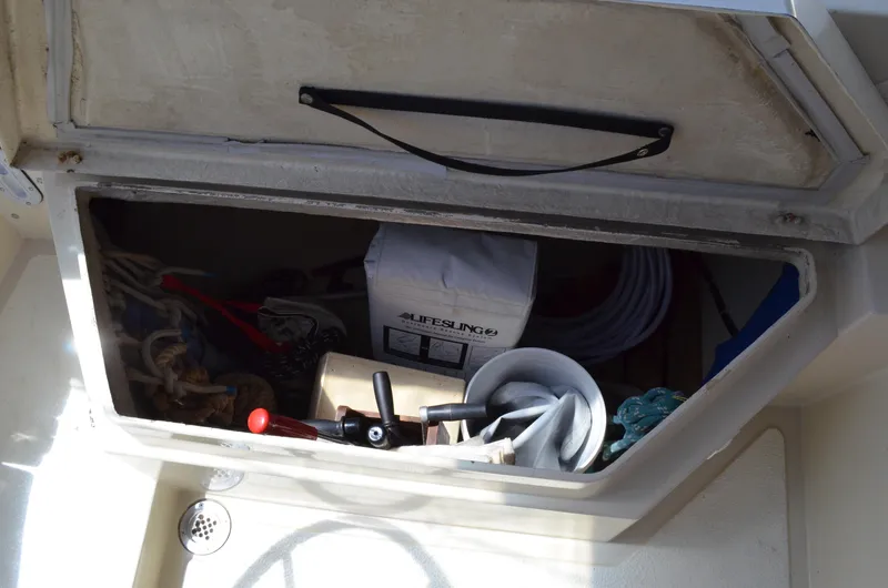 Slide: The Image of Storage compartment on a 1980 Cooper 416 Pilothouse boat, containing ropes and equipment. - 17