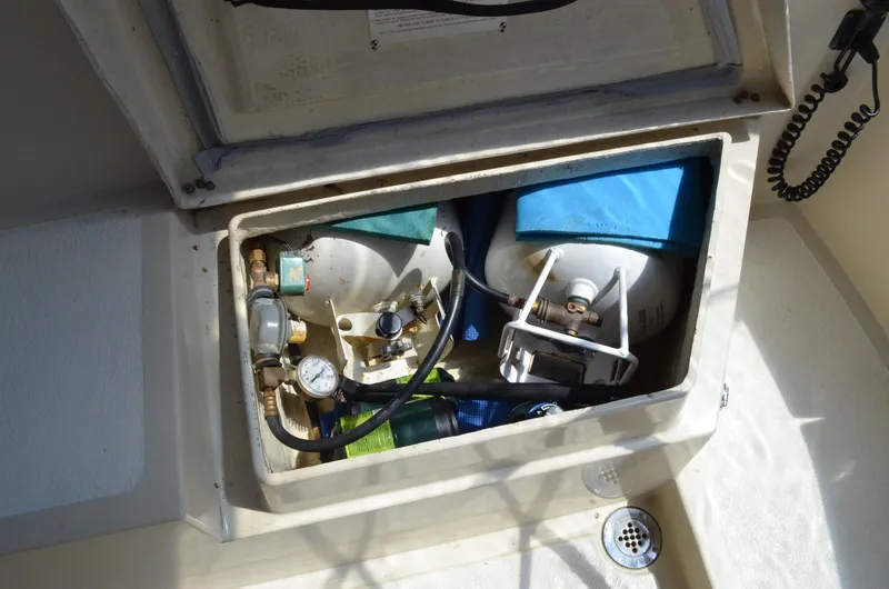 Slide: The Image of Storage compartment with gas cylinders on a 1980 Cooper 416 Pilothouse boat. - 18
