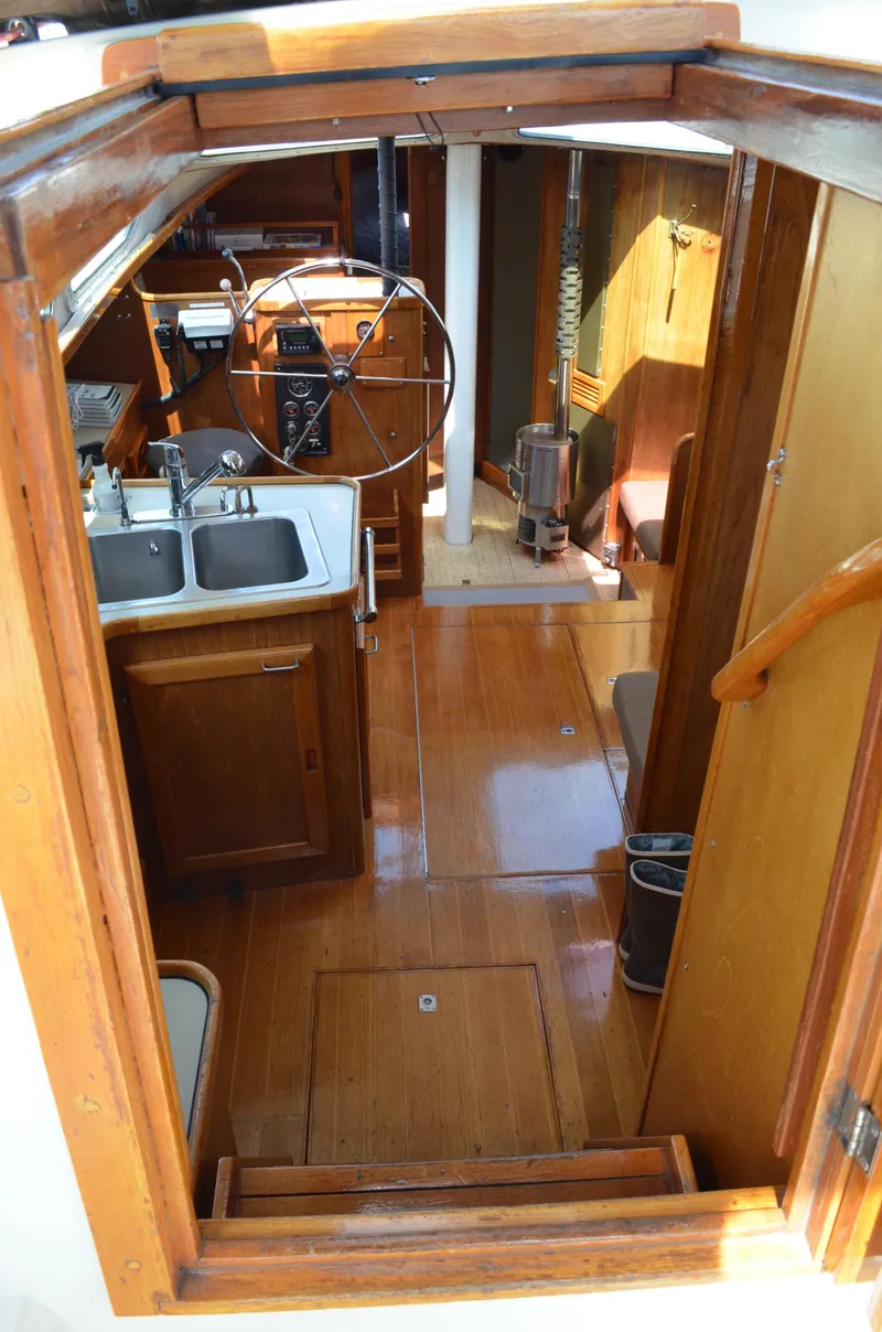 Slide: The Image of Interior view of 1980 Cooper 416 Pilothouse, featuring wooden cabinetry and steering wheel. - 23