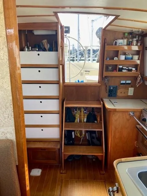 Slide: The Image of 1980 Cooper 416 Pilothouse interior with wooden cabinetry and nautical decor. - 24