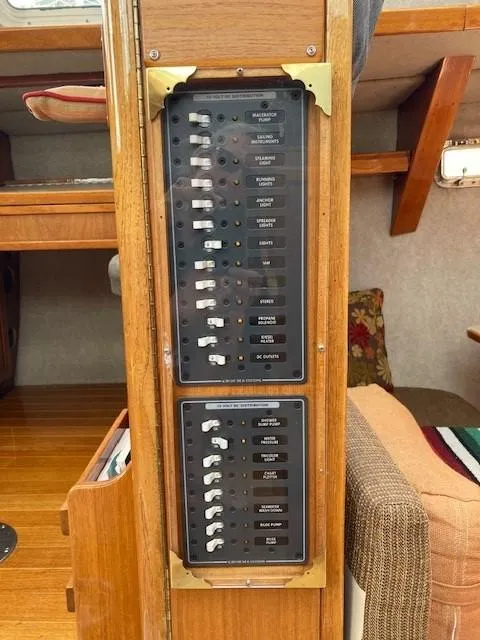 Slide: The Image of Electrical panel inside a 1980 Cooper 416 Pilothouse boat, featuring switches and labels. - 29