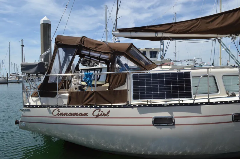 Slide: The Image of 1980 Cooper 416 Pilothouse sailboat with solar panels docked in marina. - 3