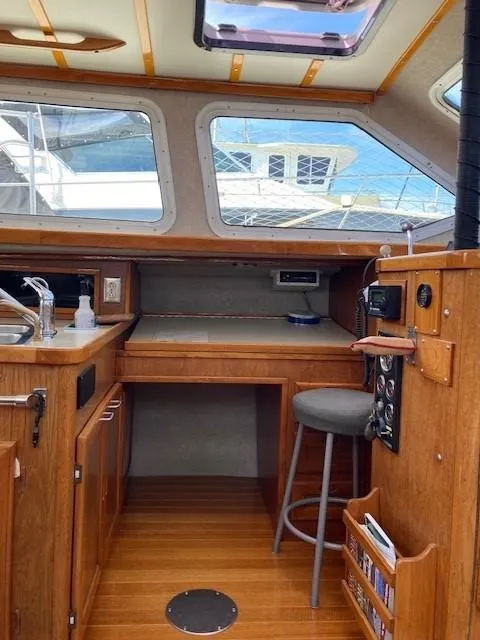 Slide: The Image of 1980 Cooper 416 Pilothouse interior with wooden cabinetry and seating. - 31
