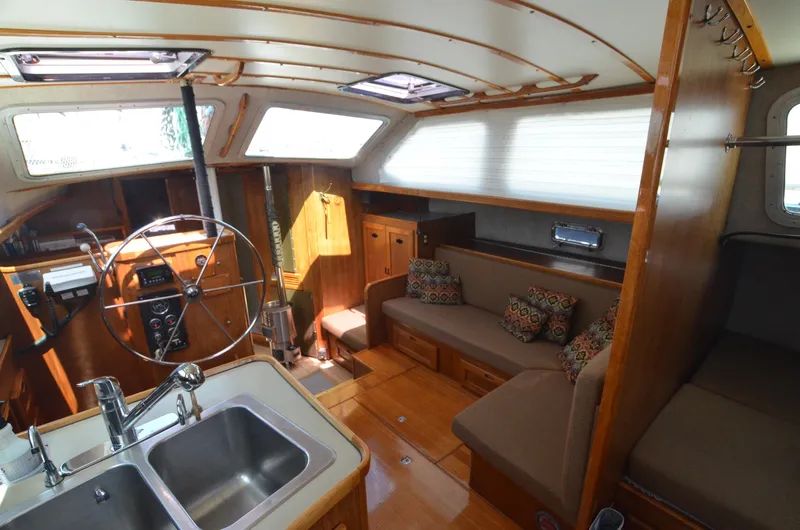 Slide: The Image of Interior of 1980 Cooper 416 Pilothouse with wooden finish and cozy seating area. - 32