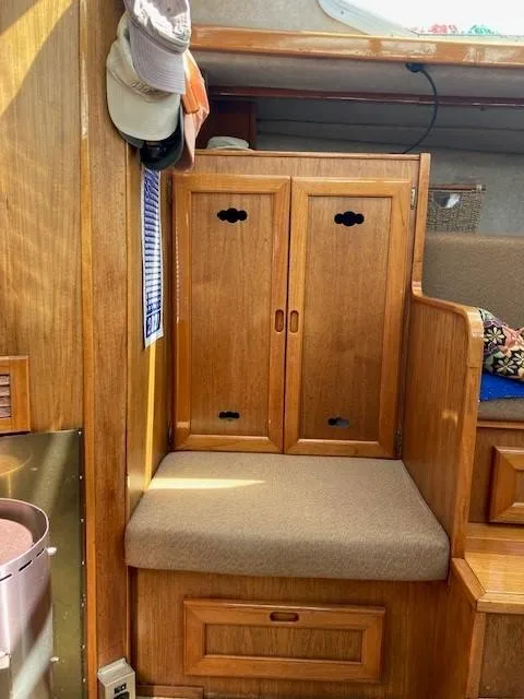 Slide: The Image of 1980 Cooper 416 Pilothouse interior with wooden cabinets and cushioned seating. - 37