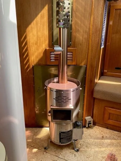 Slide: The Image of Vintage Cooper 416 Pilothouse interior with a classic metal stove, 1980 model. - 38