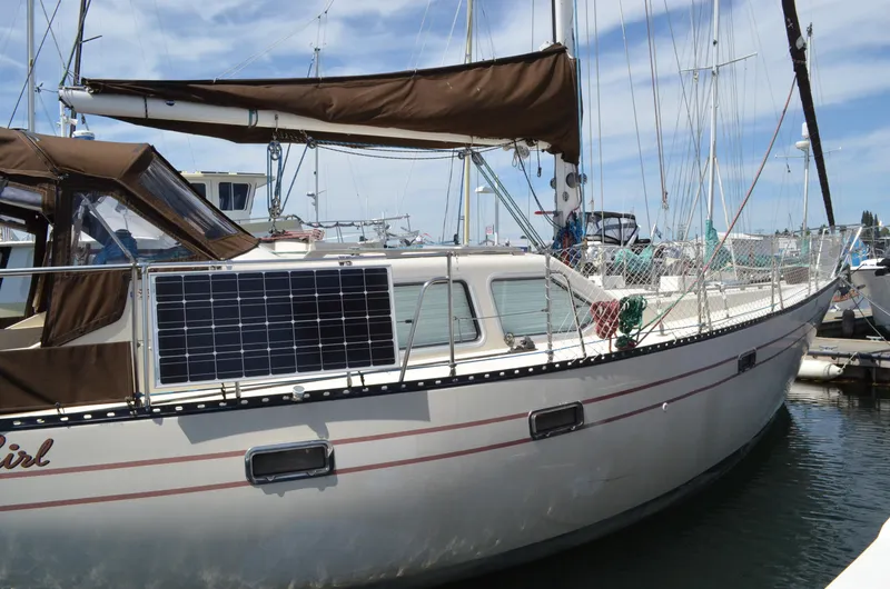 Slide: The Image of 1980 Cooper 416 Pilothouse sailboat with solar panel, docked in a marina. - 4