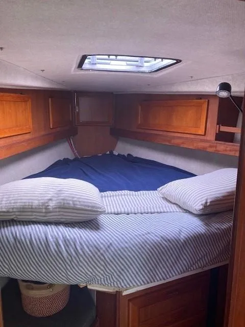 Slide: The Image of Cozy cabin interior of 1980 Cooper 416 Pilothouse with striped bedding and wooden accents. - 42
