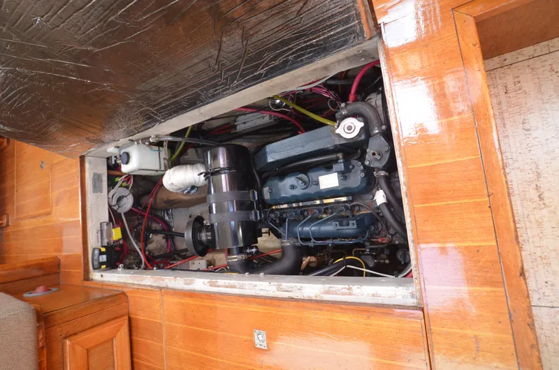 Slide: The Image of Engine compartment of a 1980 Cooper 416 Pilothouse boat, showcasing mechanical components. - 44