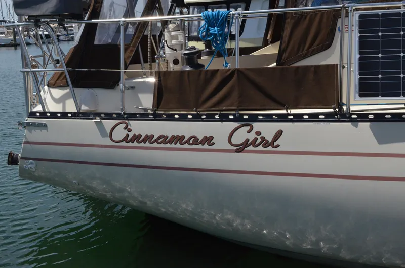 Slide: The Image of 1980 Cooper 416 Pilothouse sailboat named "Cinnamon Girl" docked in a marina. - 5