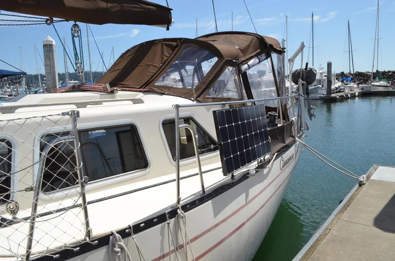 Slide: The Image of 1980 Cooper 416 Pilothouse sailboat docked with solar panels and brown canopy. - 6