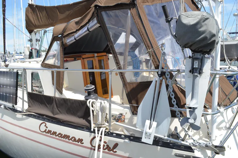 Slide: The Image of 1980 Cooper 416 Pilothouse sailboat "Cinnamon Girl" docked, featuring brown canopy and solar panels. - 8