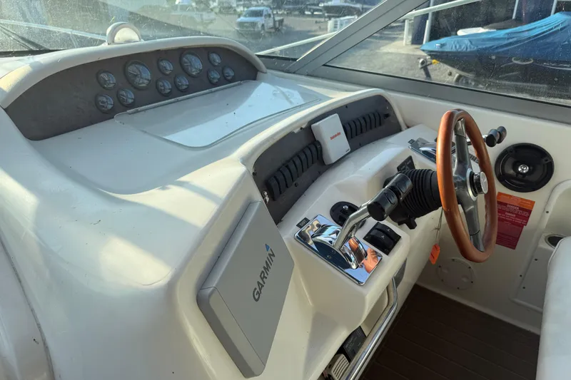 Slide: The Image of 1996 Sea Ray Sundancer 330 helm with Garmin navigation and wood-accented steering wheel. - 10
