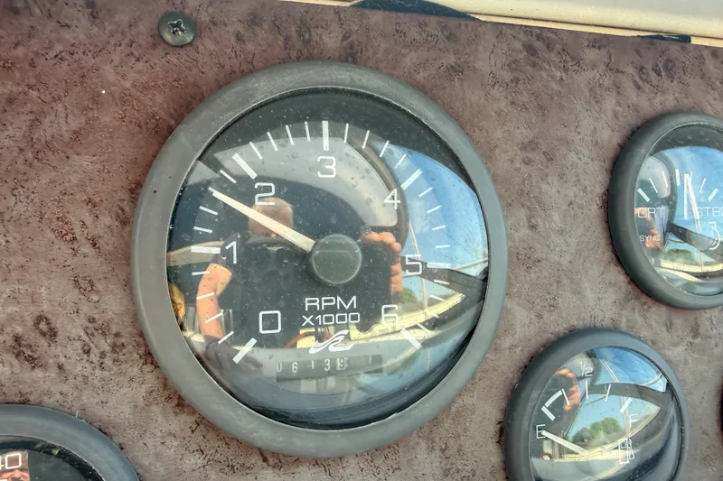 Slide: The Image of Close-up of 1996 Sea Ray Sundancer 330 dashboard gauges, showing RPM and fuel indicators. - 11