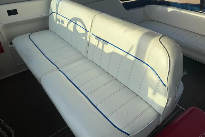Slide: The Image of White leather seating on a 1996 Sea Ray Sundancer 330 boat interior. - 13