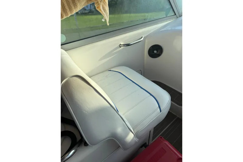 Slide: The Image of White seat on 1996 Sea Ray Sundancer 330 boat, featuring blue accents and sleek design. - 14