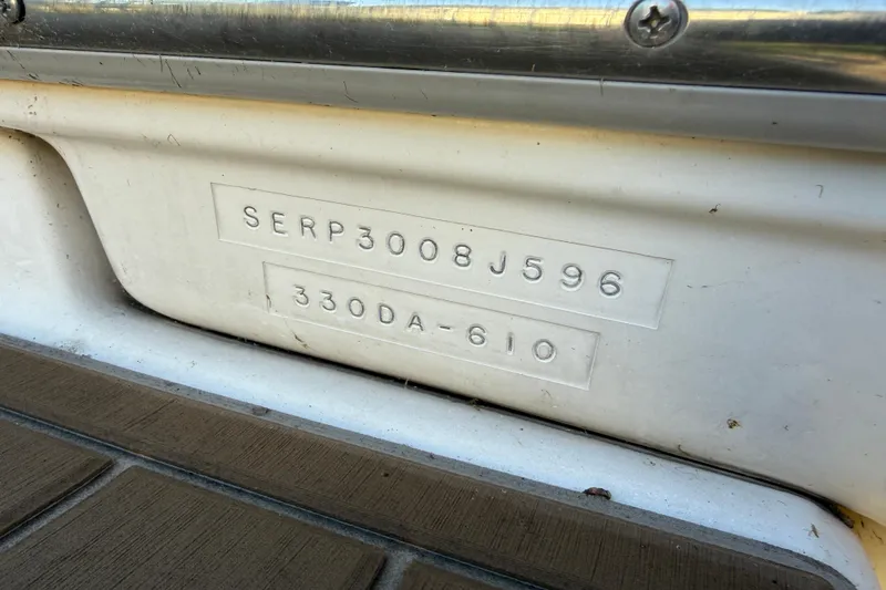 Slide: The Image of 1996 Sea Ray Sundancer 330 hull identification number on white boat surface. - 2