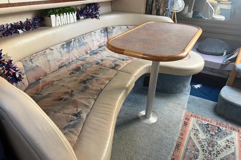 Slide: The Image of Interior of a 1996 Sea Ray Sundancer 330 with a cozy seating area and table. - 20