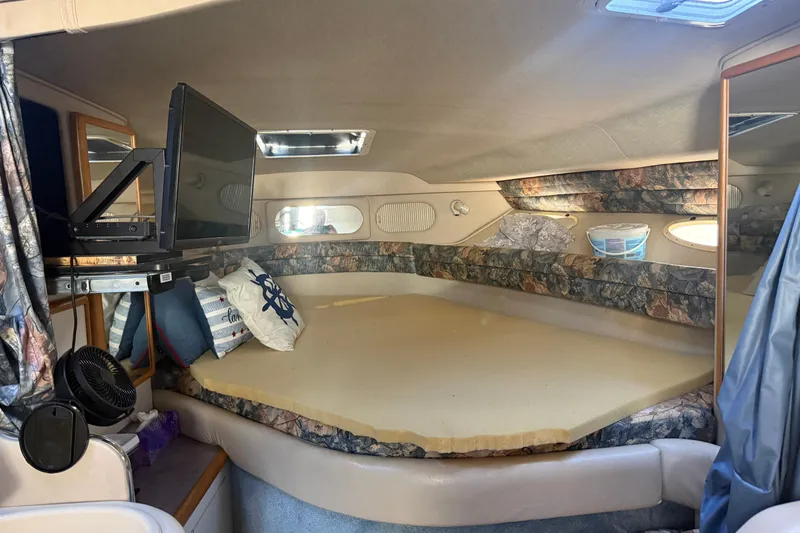 Slide: The Image of Interior cabin of a 1996 Sea Ray Sundancer 330 with bed, TV, and nautical decor. - 21