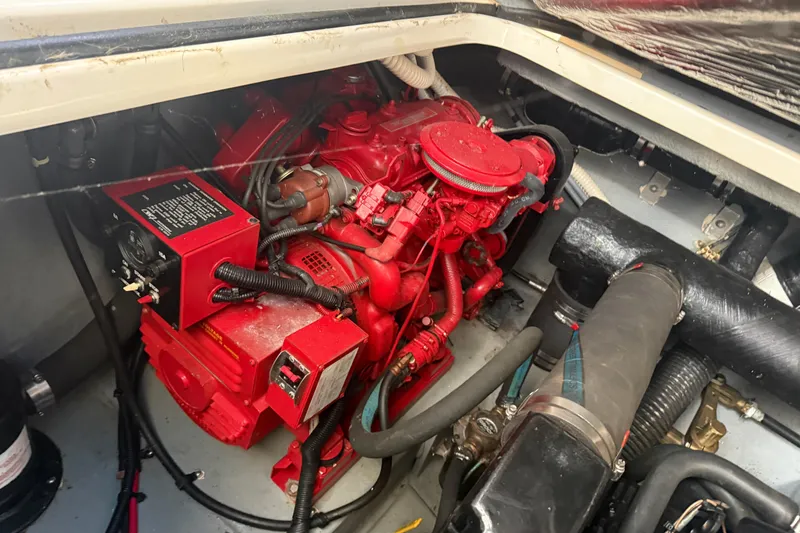 Slide: The Image of Engine compartment of a 1996 Sea Ray Sundancer 330, featuring a red engine. - 3