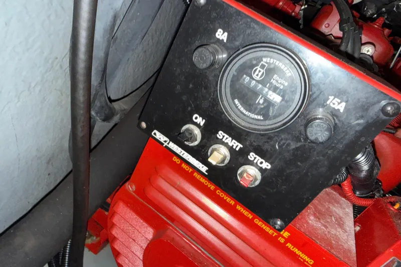 Slide: The Image of Control panel of a 1996 Sea Ray Sundancer 330 generator with start and stop buttons. - 4