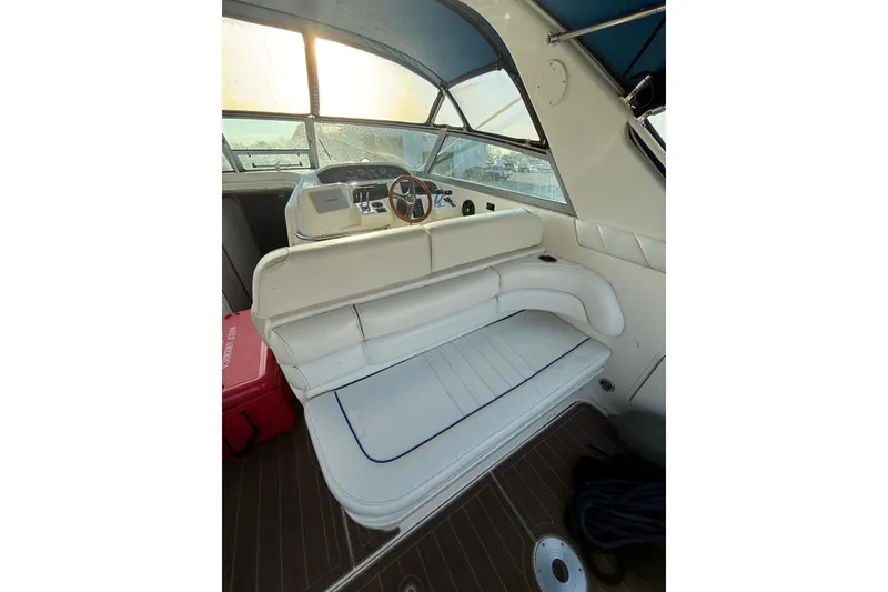 Slide: The Image of 1996 Sea Ray Sundancer 330 interior with white seating and wooden flooring. - 6