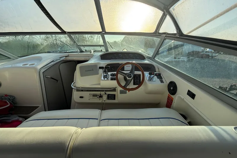 Slide: The Image of Interior view of 1996 Sea Ray Sundancer 330 boat cockpit with steering wheel and controls. - 8