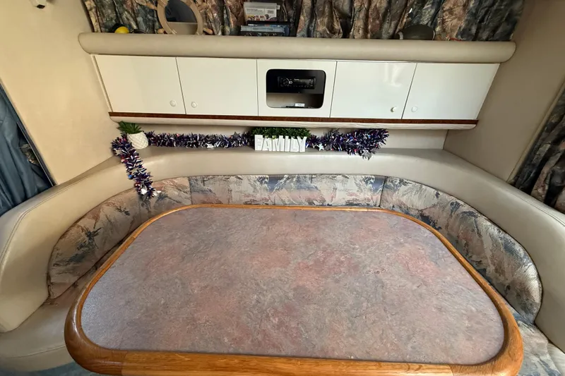 Slide: The Image of Interior of 1996 Sea Ray Sundancer 330 with cozy seating and decorative elements. - 9