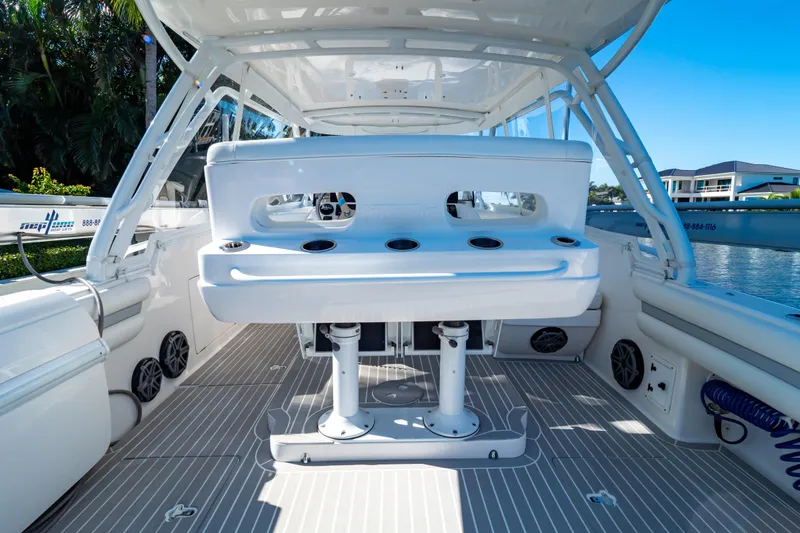 Slide: The Image of 2016 Intrepid 400 Cuddy boat interior with seating and rod holders. - 10