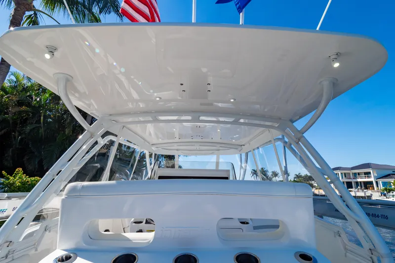 Slide: The Image of 2016 Intrepid 400 Cuddy boat with sleek white design and spacious cockpit. - 102